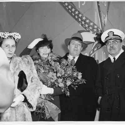 Mrs. William Gallieane holding roses with people in front of vessel