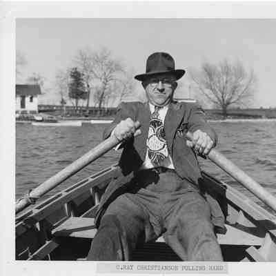 C. Ray Christianson rowing hard in row boat