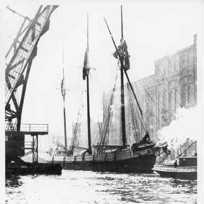 Grace M. Filer being towed in river by tugboat