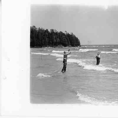 Two men in the water with rope