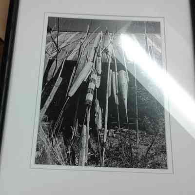 Framed photograph of Buoys leaning against building of Gills Rock