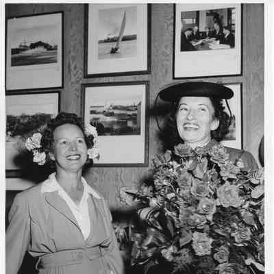 Mrs. Sydney T. Smith holding roses in Leathem D. Smith office