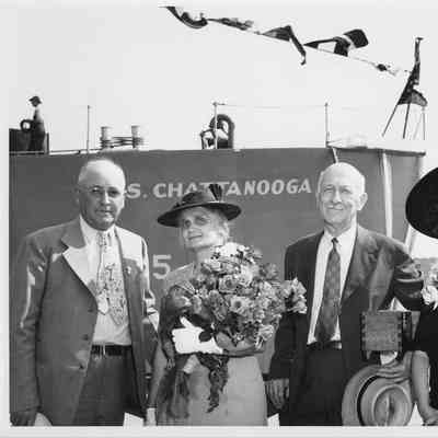 L.D. Smith and christening party standing in front of USS Chattanooga