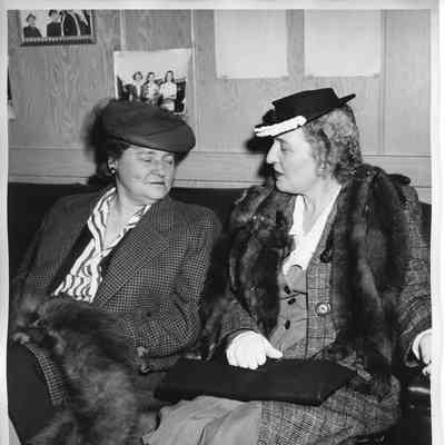 Two unidentified women sitting on couch