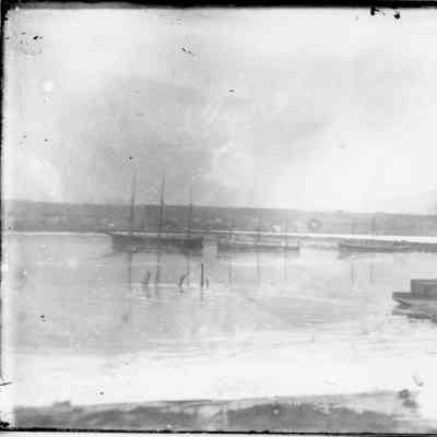 Several sailing vessels with sails down in water