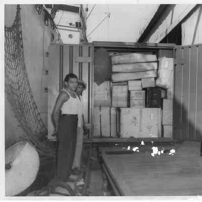 Open Safeway Shipping container filled with cargo next to ship