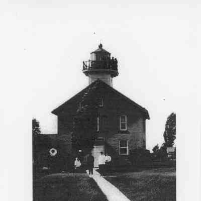 Green Island Lighthouse with people standing outside