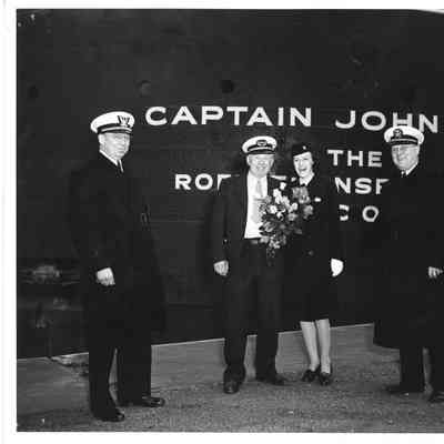 Captain John Roen and woman with flowers