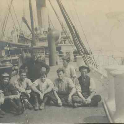 Group sitting on deck of ship