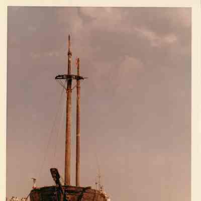 View of bow of the Alvin Clark in water with boats alongside