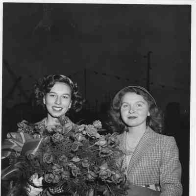 Miss Felice Ferguson standing with roses in hand 1943