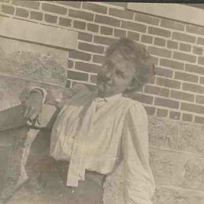 Young woman seated on stairs