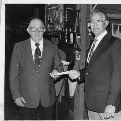 C. Ray Christianson receiving a check from DR. E.S. Minor 1988