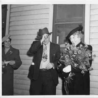 Mrs. William E. Wagener standing by house