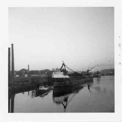 Tugboat towing freighter October 1961