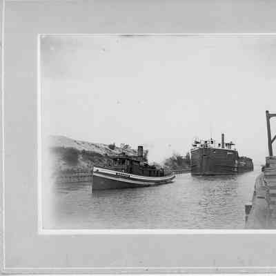 Tug Golden pulling a ship through a canal