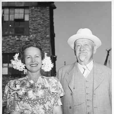 Alva Smith alongisde man in hat at christening of PF-64 USS Knoxville