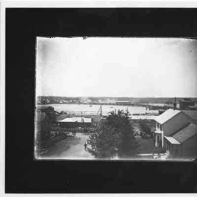 Buildings, waterfront, railroad bridge on right
