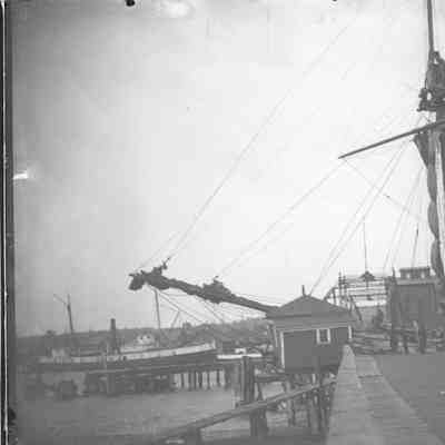Variety of vessels dockside with bridge in background