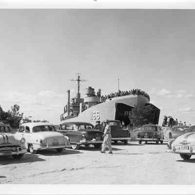 People standing on deck of LST-1166 behind parked cars September 4, 1966