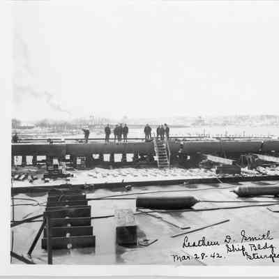 Men standing on hull at Leathem D. Smith Shipbuilding Co. 1942