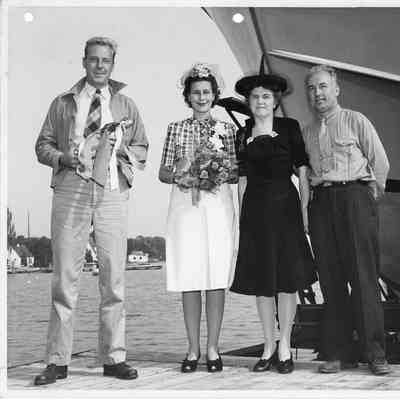 Sponsor party posing in front of P-573 at Peterson Boat Works September 11, 1944