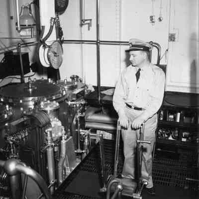 Officer at controls of lighthouse tender Hollyhock