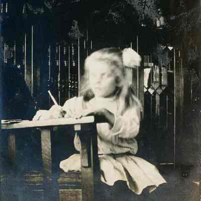 Young girl writing at table