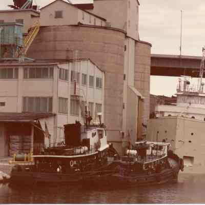 Tug Bonnie Selvick and another tug and one ship at dock