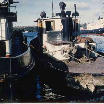 Tugboat tied to another boat