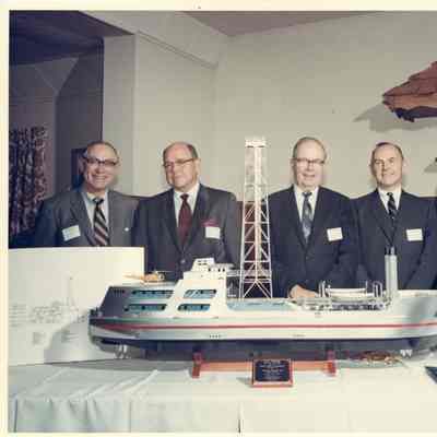 Group of men posing behind Aloca Seaprobe model