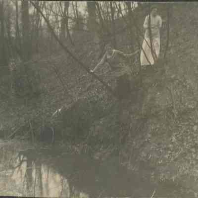 women walking along creek