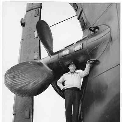 Joe O'Boyle standing underneath propeller