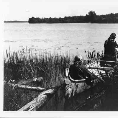 Two people in birch bark canoe