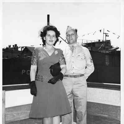 Woman and serviceman posing in front of PC vessel