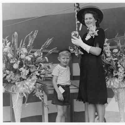 Mrs. John Roen with son at lauch