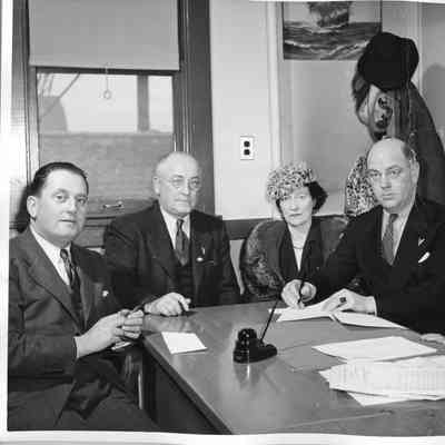 Captain Polking Horne, L.D. Smith, Mrs. Gallieane, Rob Carruthers signing documentation
