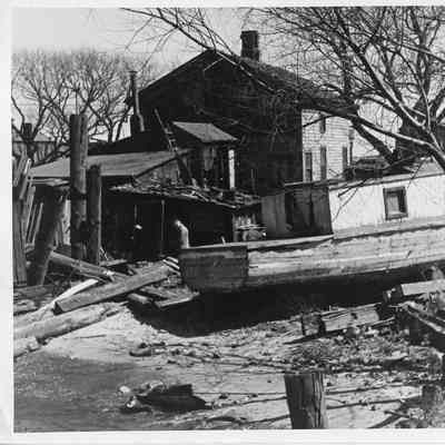 Old houseboat in front of house