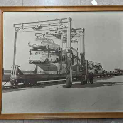 Framed photograph of trains transporting cars
