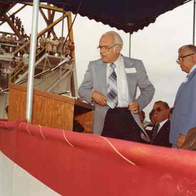 Speaker at podium during christening of Napolean
