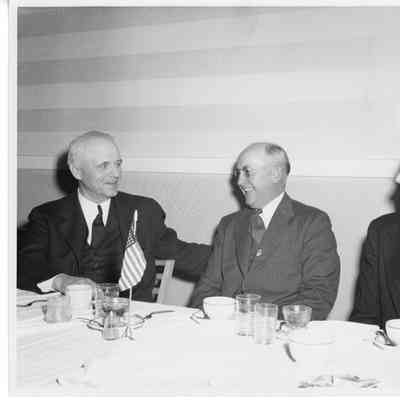 L.D. Smith with two men at dinner table