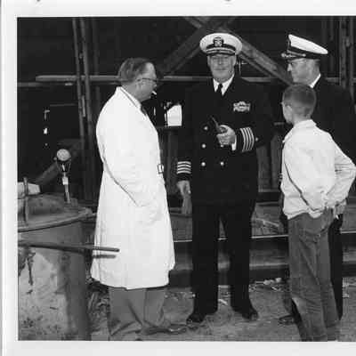 C. Ray Christianson and young boy talking with men in uniform September 6, 1952