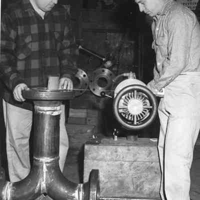 two men making something