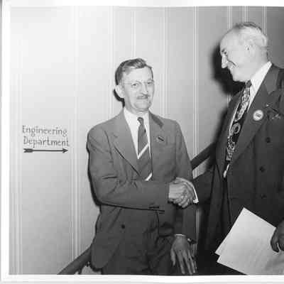 Wolcott E. Spofford shaking hands with unidentified man