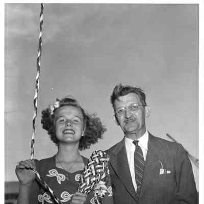 Patsy Smith holding christening bottle alongside Wolcott E. Spofford