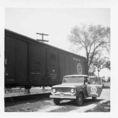 Ahnapee and Western car next to rail car in Sawyer May 1964