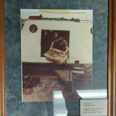 Framed photograph of a man unloading a fish box