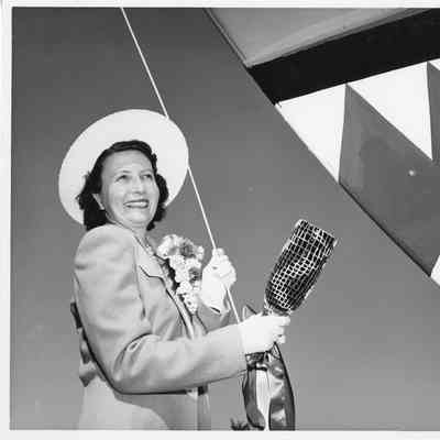 P-571 ship sponsor holding christening bottle pre-christening at Peterson Boat Works July 15, 1944