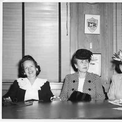 Alva Smith and two women seated at conference table