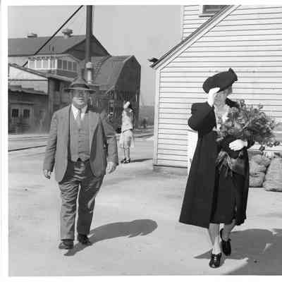Unidentified man walking alongside Mrs. William Wagener at PC-1177 christening